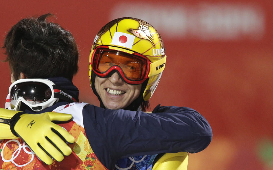 Japan's Noriaki Kasai smiles after winning the bronze during the ski jumping large hill team competition at the 2014 Winter Olympics, Monday, Feb. 17, 2014, in Krasnaya Polyana, Russia. (AP Photo/Matthias Schrader)