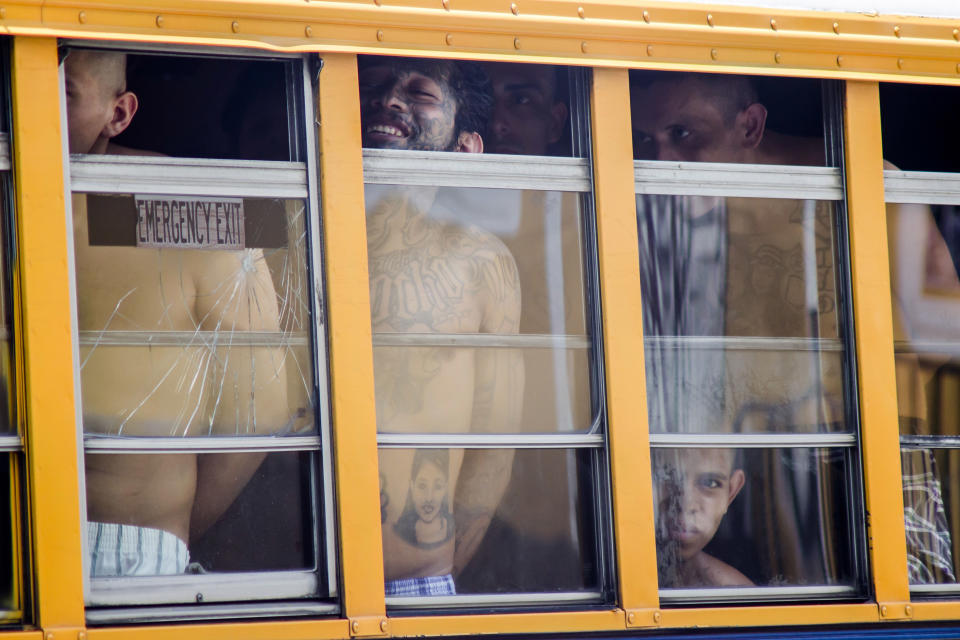 FILE - In this June 16, 2016 file photo, inmates ride in a bus out of the Cojutepeque prison in El Salvador. El Salvador had a homicide rate of 50.3 per 100,000 people in 2018. President Donald Trump said that he is cutting off nearly $500 million in aid to Honduras, Guatemala and El Salvador help reduce immigration. The aid is meant to promote democracy-building, good governance, trade, agriculture, education, health and public safety and law enforcement. Experts say all of those areas play a direct role in whether people feel they can survive in their home country.(AP Photo/Salvador Melendez, File)