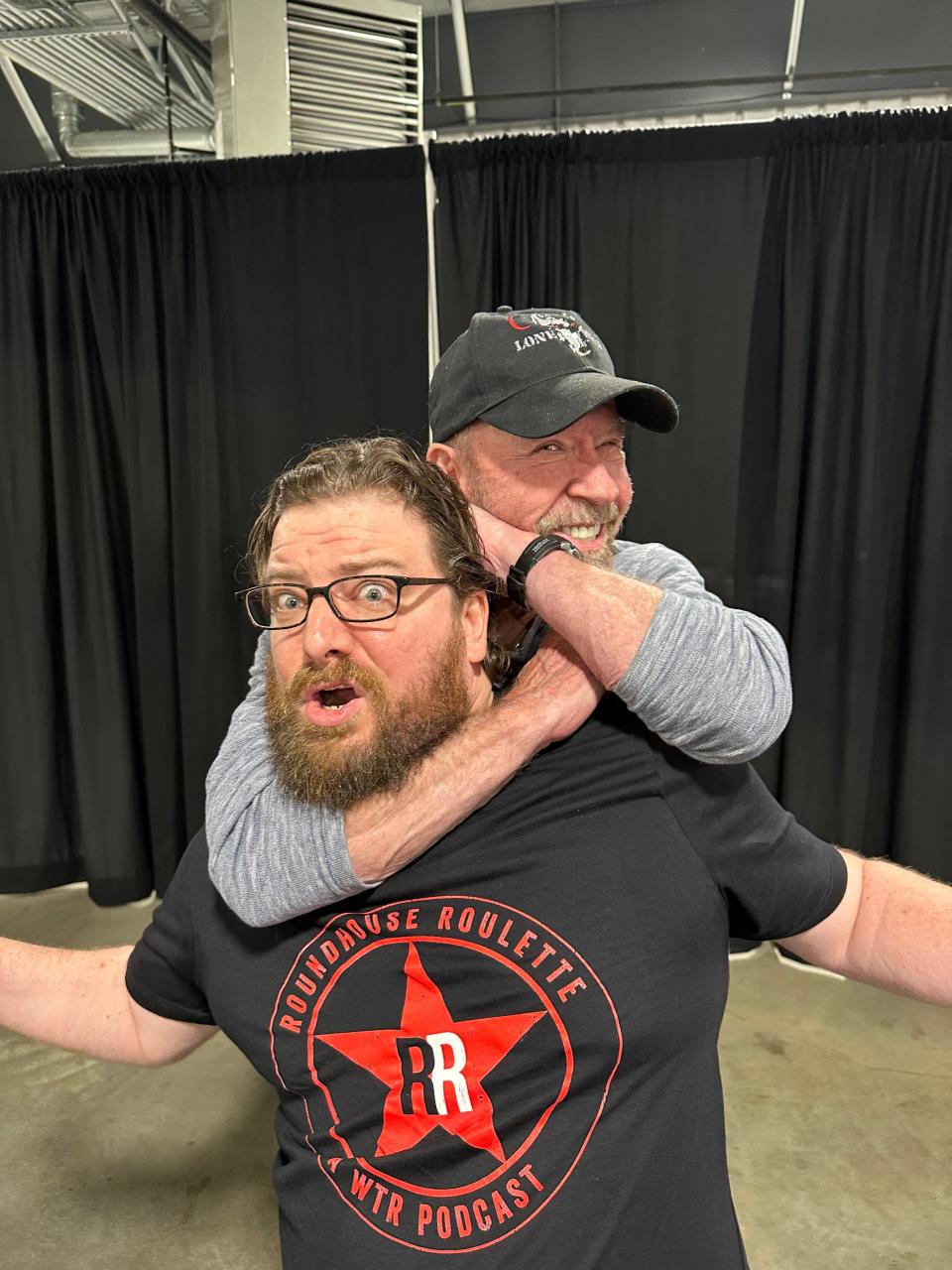 Chuck Norris puts Tennessee Warblers band member Adam Dalton in a fake sleeper hold in June 2023 at Nashville Comicon. Dalton and his fellow band members serenaded the popular veteran actor with the "Walker, Texas Ranger" TV show theme song