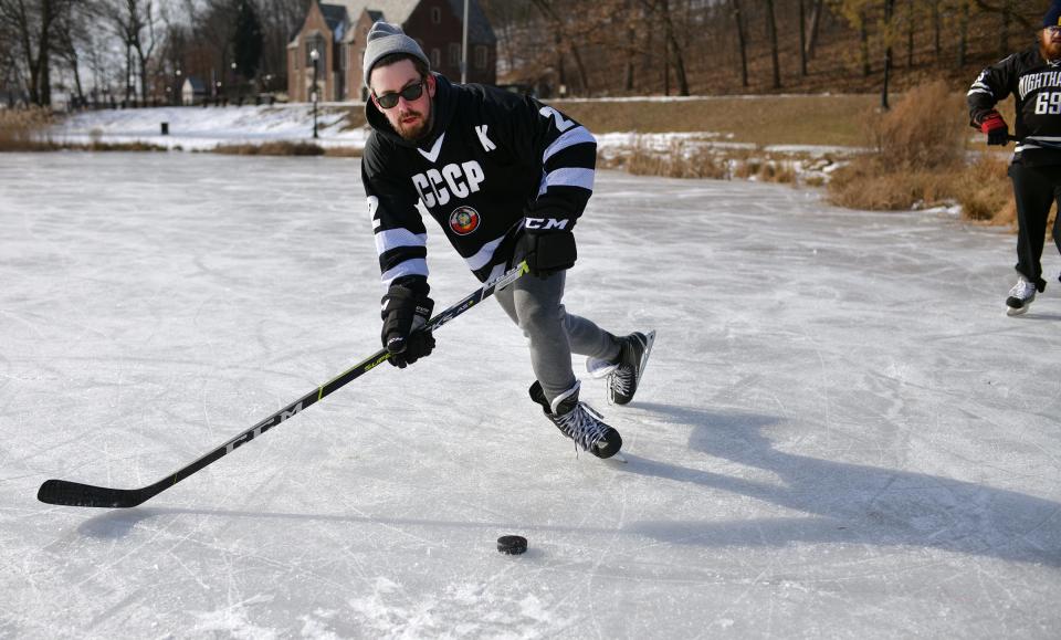 Mike Russell shoots while practicing for a pond hockey game at Elm Park Sunday.