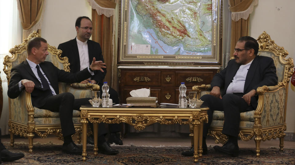 French presidential envoy Emmanuel Bonne, left, talks with Secretary of Iran's Supreme National Security Council Ali Shamkhani during their meeting in Tehran, Iran, Wednesday, July 10, 2019. An unidentified interpreter sits second left. (AP Photo/Vahid Salemi)