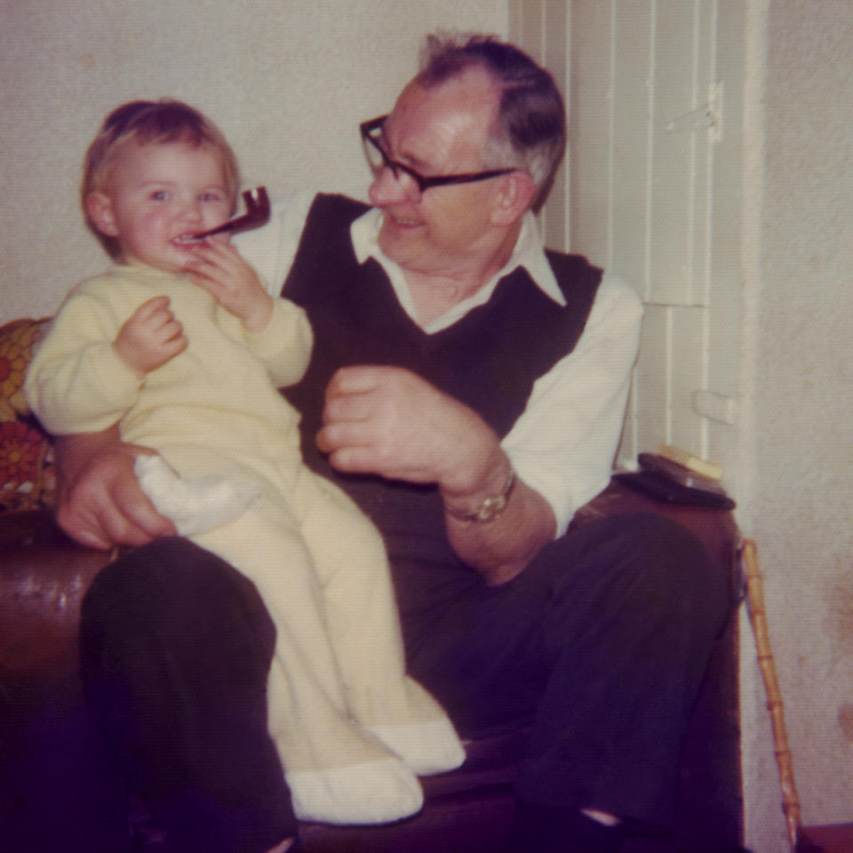 A child is playing with their grandfather's smoke pipe