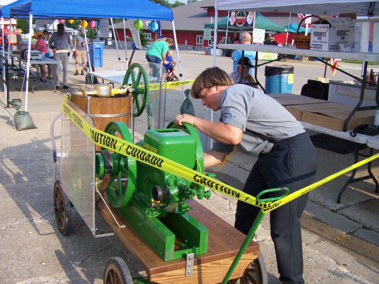 Perry Gingrich of rural Chariton fires up an ice cream churn powered by a 1930s John Deere engine while in Milo for RAGBRAI on Wednesday, July 24, 2024.