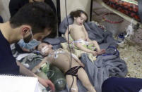 <p>This image made from video released by the Syrian Civil Defense White Helmets, which has been authenticated based on its contents and other AP reporting, shows medical workers treating toddlers following an alleged poison gas attack in the opposition-held town of Douma, in eastern Ghouta, near Damascus, Syria, Sunday, April. 8, 2018. (Photo: Syrian Civil Defense White Helmets via AP) </p>