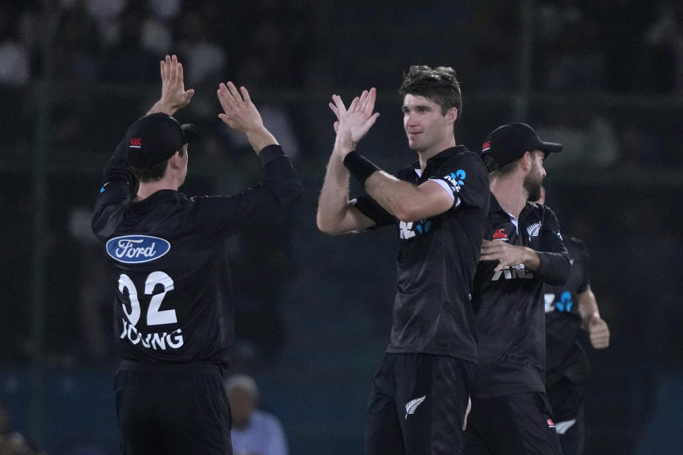 New Zealand's Henry Shipley, center, celebrates with teammates after taking the wicket of Pakistan's Babar Azam during the fifth one-day international cricket match between New Zealand and Pakistan, in Karachi, Pakistan, Sunday, May 7, 2023. (AP Photo/Fareed Khan)