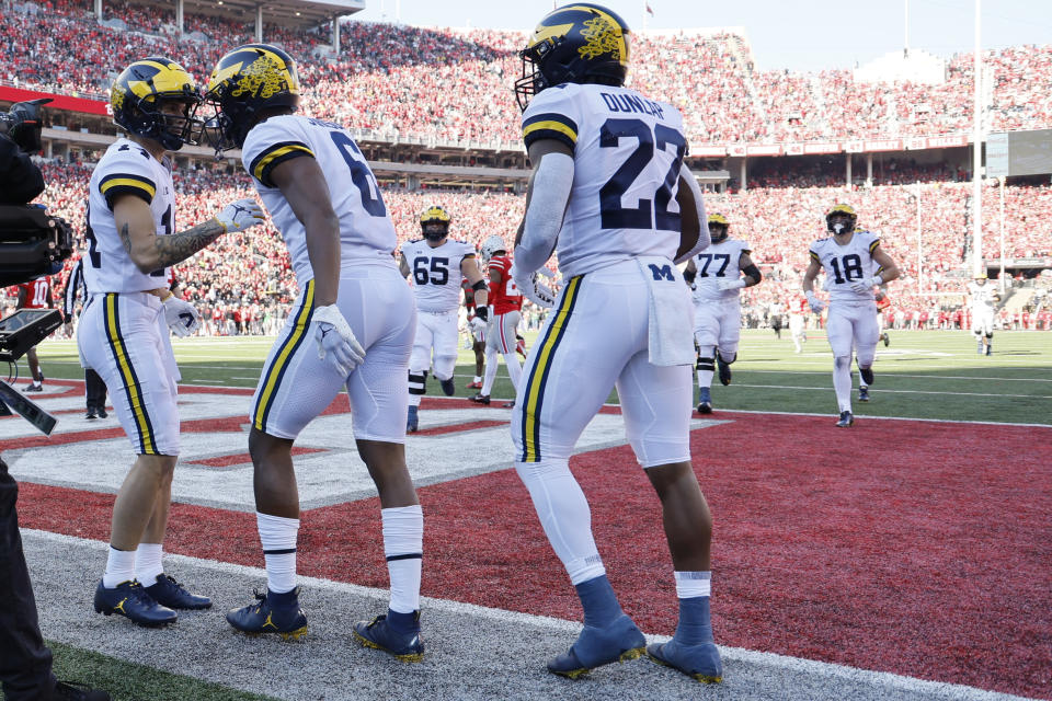 Michigan Cornelius Johnson, center, celebrates with teammates after his touchdown against Ohio State during the first half of an NCAA college football game on Saturday, Nov. 26, 2022, in Columbus, Ohio. (AP Photo/Jay LaPrete)