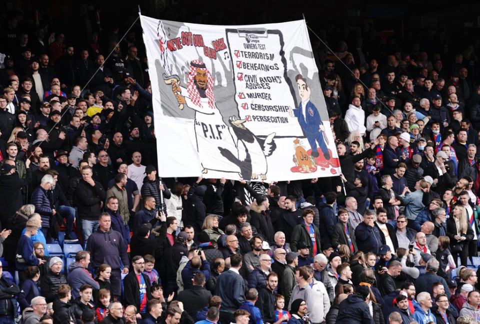 Crystal Palace fans in the Holmesdale End stand hold up a banner before the match with Newcastle (Jonathan Brady/PA) (PA Wire)