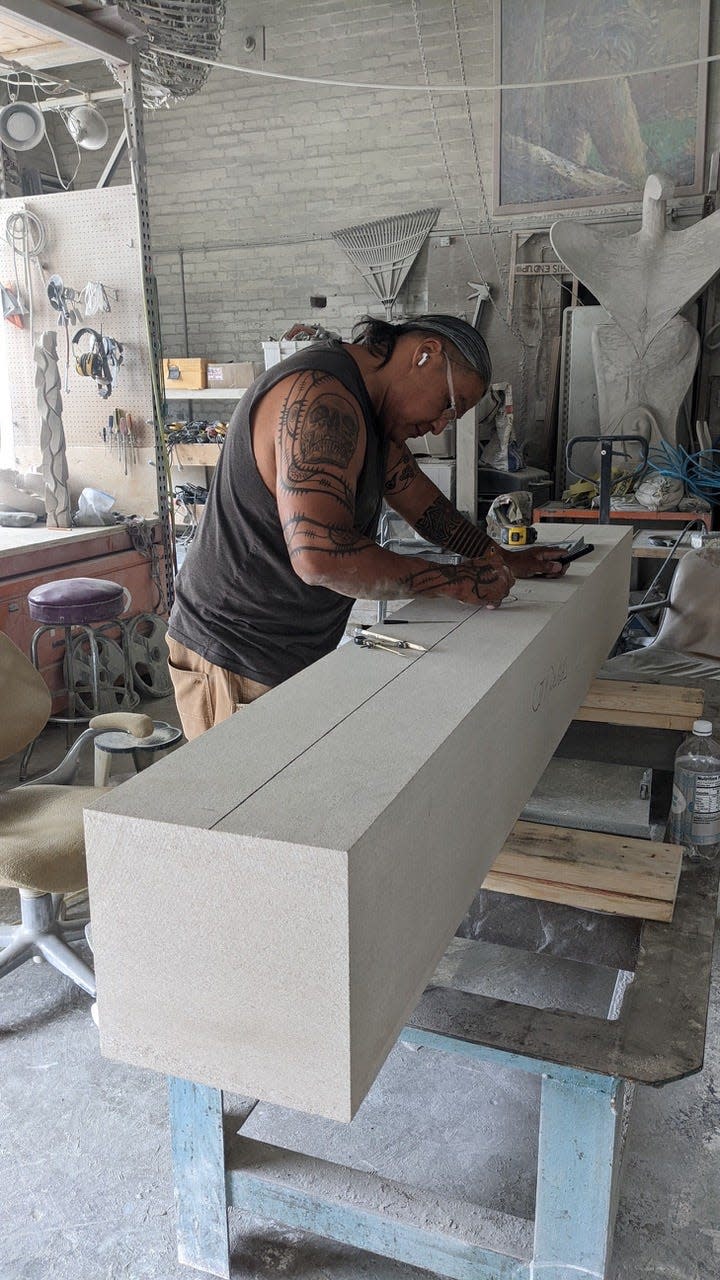 Jason Quigno works on Seven Grandfathers at his Grand Rapids studio. The sculpture will be installed at the Saugatuck-Douglas History Center in Douglas on Thursday, July 28.