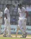 India's Mayank Agarwal , left, talks with Axar Patel during the day two of their second test cricket match with New Zealand in Mumbai, India, Saturday, Dec. 4, 2021.(AP Photo/Rafiq Maqbool)