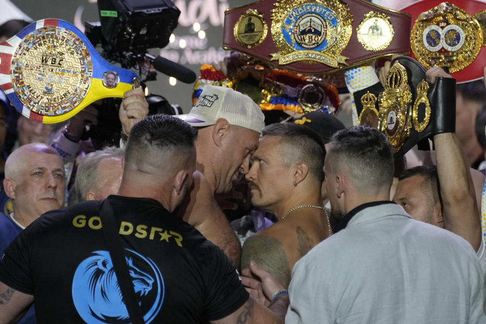 Heavyweight boxers Britain's Tyson Fury, center left, and Ukraine's Oleksandr Usyk face off during the weigh-in in Riyadh, Saudi Arabia, Friday, May 17, 2024, prior to their undisputed heavyweight championship fight on Saturday. (AP Photo/Francisco Seco)