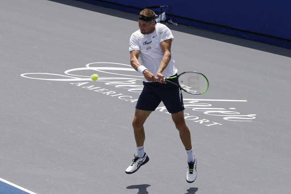 Orlando Storm player Tennys Sandgren, returns a serve at the start of the Worldteam Tennis tournament at The Greenbrier Resort Sunday July 12, 2020, in White Sulphur Springs, W.Va. (AP Photo/Steve Helber)