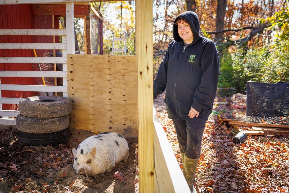 Chelsea Rumbaugh, of Cumberland Township, poses for a portrait with her pig, Kevin Bacon, after he was finally captured following two weeks on the run, Tuesday, Oct. 31, 2023, in Cumberland Township.