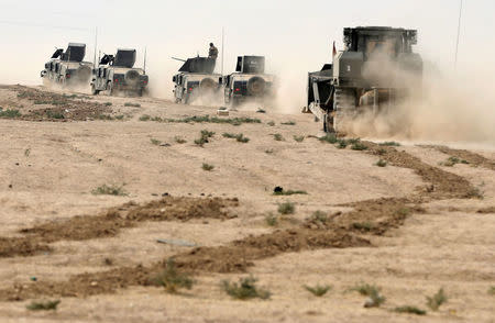 Iraqi special forces soldiers drive in a desert near Mosul, Iraq October 25, 2016. REUTERS/Goran Tomasevic