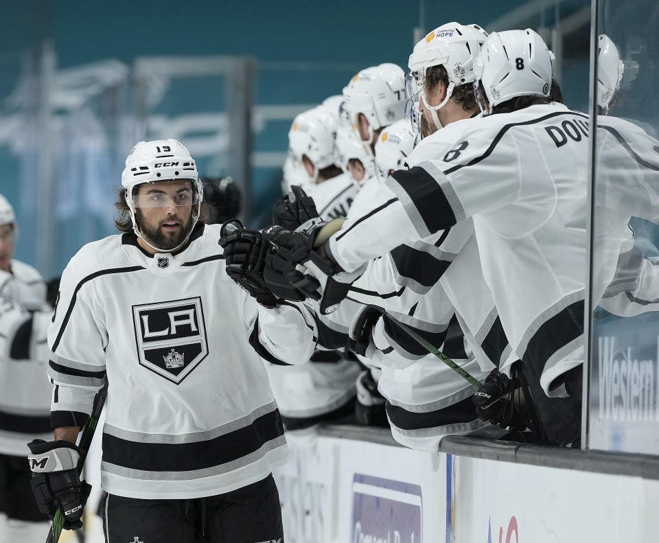 Los Angeles Kings right wing Alex Iafallo (19) is congratulated by teammates after scoring a goal against the San Jose Sharks during the first period of an NHL hockey game Friday, April 9, 2021, in San Jose, Calif. (AP Photo/Tony Avelar)