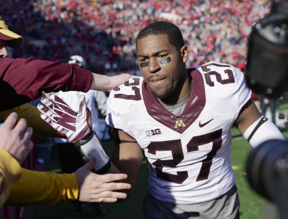 Minnesota running back David Cobb (27) celebrates with fans following an NCAA college football game against Nebraska in Lincoln, Neb., Saturday, Nov. 22, 2014. Minnesota won 28-24. (AP Photo/Nati Harnik)