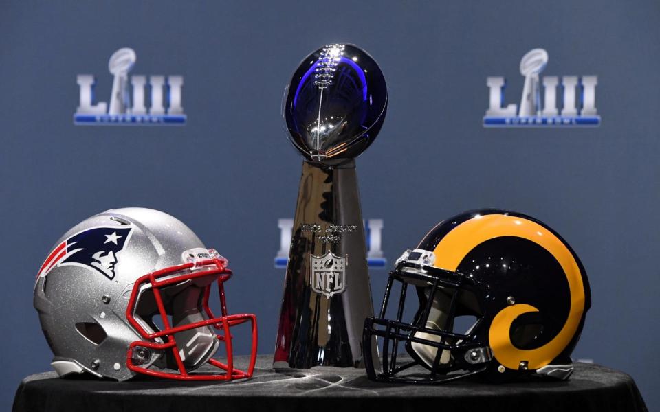 The Vince Lombardi trophy and helmets of the New England Patriots and Los Angeles Rams, who will compete in the Super Bowl on Sunday night - USA TODAY Sports