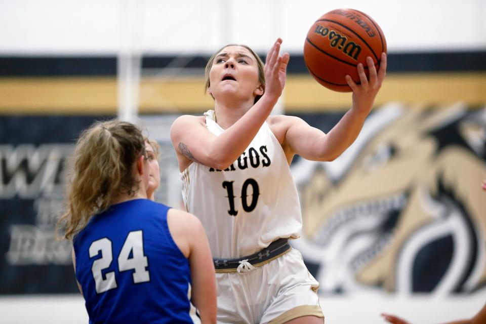 Argos senior Samantha Redinger (10) puts up a layup around Bethany Christian senior Mariah Stoltzfus during a girls basketball game Thursday, Dec. 21, 2023, at Argos High School.