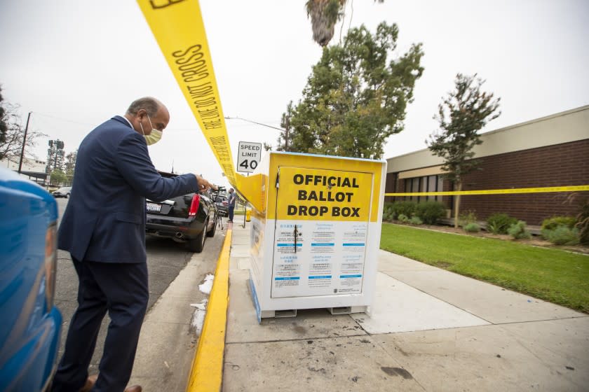 BALDWIN PARK, CA - OCTOBER 19: Baldwin Park mayor Manuel Lozano views the fire damage to the official ballot drop box where ballots were set on fire outside the Baldwin Park Library in Baldwin Park Monday, Oct. 19, 2020. Authorities are investigating a fire which damaged an official ballot drop box Sunday night in Baldwin Park, damaging countless ballots in the process. The box was discovered on fire at around 8 p.m., according to Baldwin Park police. (Allen J. Schaben / Los Angeles Times)