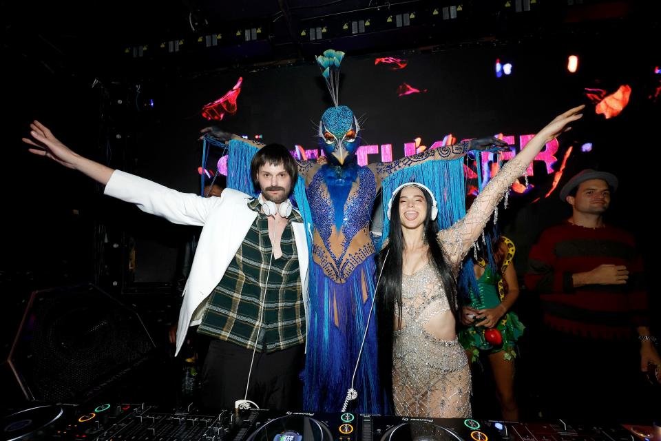 Heidi Klum (center) dressed as a peacock and danced with party guests Tucker Halpern (left) and Sofi Tukker during her 22nd annual Halloween party.