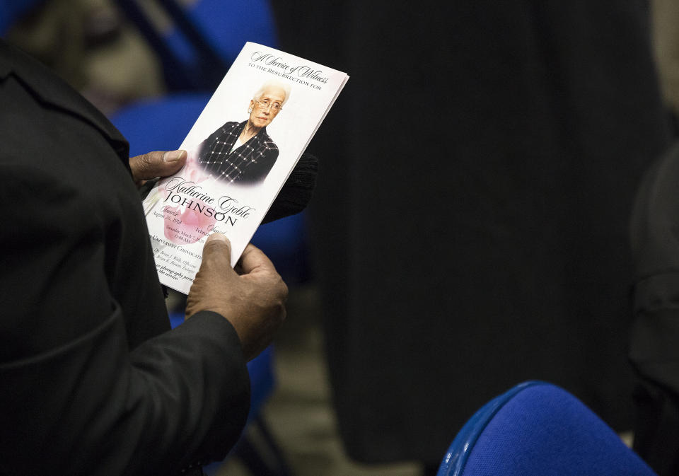 A guest holds a program during a memorial service to honor NASA mathematician Katherine Johnson on Saturday, March 7, 2020, at Hampton University Convocation Center in Hampton, Va. Johnson, a mathematician who calculated rocket trajectories and earth orbits for NASA’s early space missions and was later portrayed in the 2016 hit film “Hidden Figures,” about pioneering black female aerospace workers died on Monday, Feb. 24, 2020. She was 101. (Kaitlin McKeown /The Virginian-Pilot via AP)