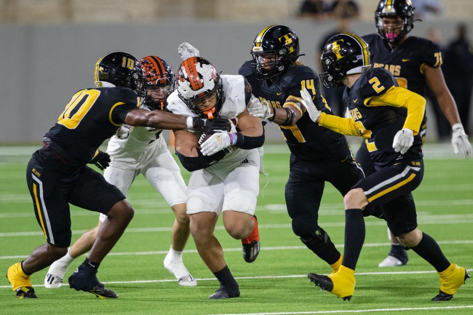 Refugio full back Jordan King pushes through a pack of a Timpson defenders during the Class 2A, Division I state semifinal on Thursday night at the Berry Center in Cypress. 