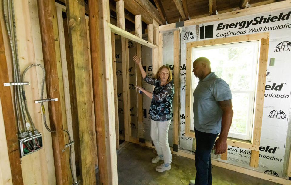 Open Arms Village Executive Director Pam McBride and Davieoyn Hopson, mental health coordinator, check out the progress on the organization's expansion project.