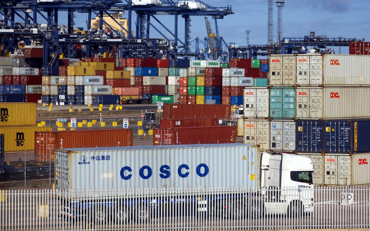 A haulage truck passes shipping containers on the dockside at the Port of Felixstowe Ltd - Chris Ratcliffe/Bloomberg