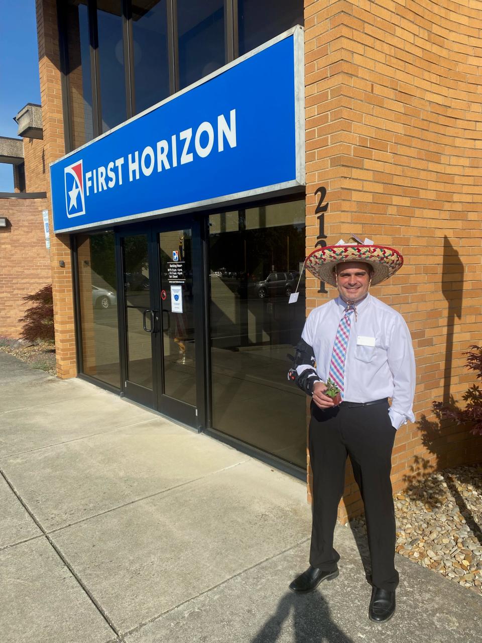 First Horizon Bank Powell branch manager Adrian Allman models the sombrero adorned with business cards from people in the community that earned his branch second place in the Knoxville competition.