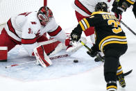 Carolina Hurricanes goaltender Frederik Andersen (31) pounces on the puck after a shot by Boston Bruins center Patrice Bergeron (37) during the second period of an NHL hockey game, Tuesday, Jan. 18, 2022, in Boston. (AP Photo/Charles Krupa)