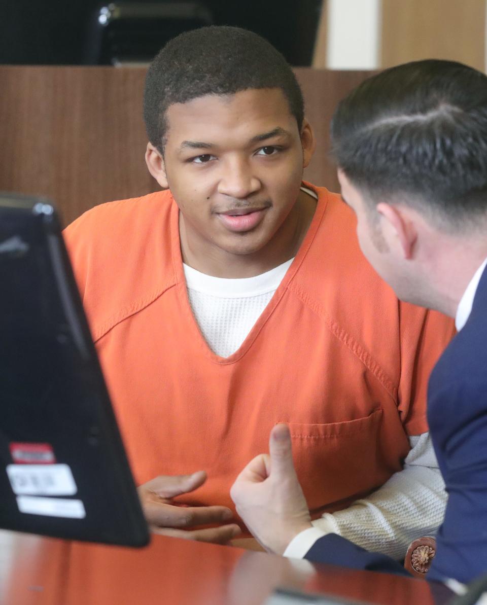 Kavon Jackson talks with his defense attorney Jake Will on Monday before entering a guilty plea for the fatal shooting of William Howell II in 2021.