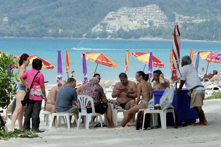 Foreigners are seen relaxing at the Patong beach in Phuket, southern Thailand, on December 23, 2005. An estimate suggests that by 2050 Asia will account for 63 percent of the world's senior citizens, who will become increasingly important to economies, especially as medical advances extend lifespans