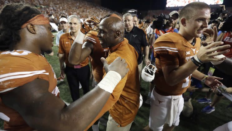 Texas coach Charlie Strong celebrates after his team beat Notre Dame on Sunday. (AP)
