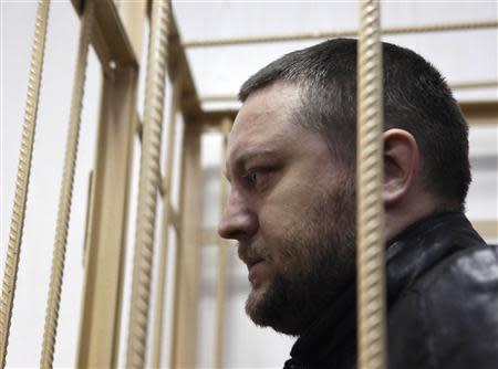 Yury Zarutsky looks out from the defendant's holding cell during a court hearing in Moscow in this March 7, 2013 file photo. REUTERS/Maxim Shemetov/Files