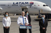 FILE - In this Thursday, Jan. 28, 2021 file photo, President Sebastian Pinera speaks in front of the plane carrying the country's first batch of the CoronaVac vaccine for COVID-19 developed by Chinese biopharmaceutical company Sinovac Biotech, at Arturo Merino airport in Santiago, Chile. “Today,” he said, “is a day of joy, emotion and hope.” (AP Photo/Esteban Felix)