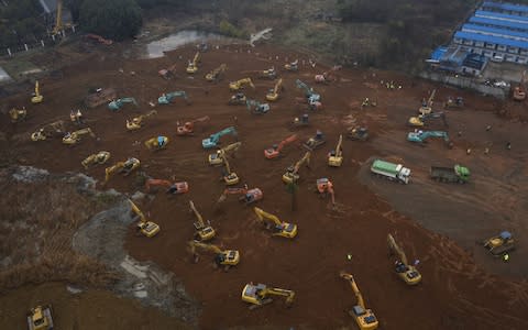 An army of excavators prepare the ground for a 1,000 bed hospital for coronavirus patients, which the Chinese authorities say will be ready in 10 days  - Credit: Getty Images