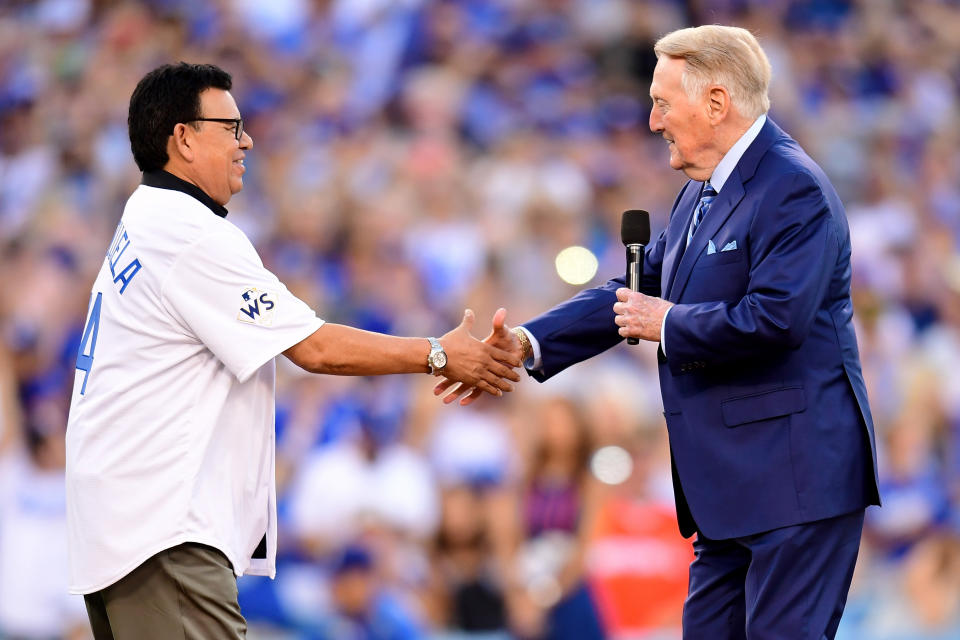 <p>Former Los Angeles Dodgers broadcaster Vin Scully shakes hands with former Los Angeles Dodgers player Fernando Valenzuela before game two of the 2017 World Series between the Houston Astros and the Los Angeles Dodgers at Dodger Stadium on October 25, 2017 in Los Angeles, California. (Photo by Harry How/Getty Images) </p>