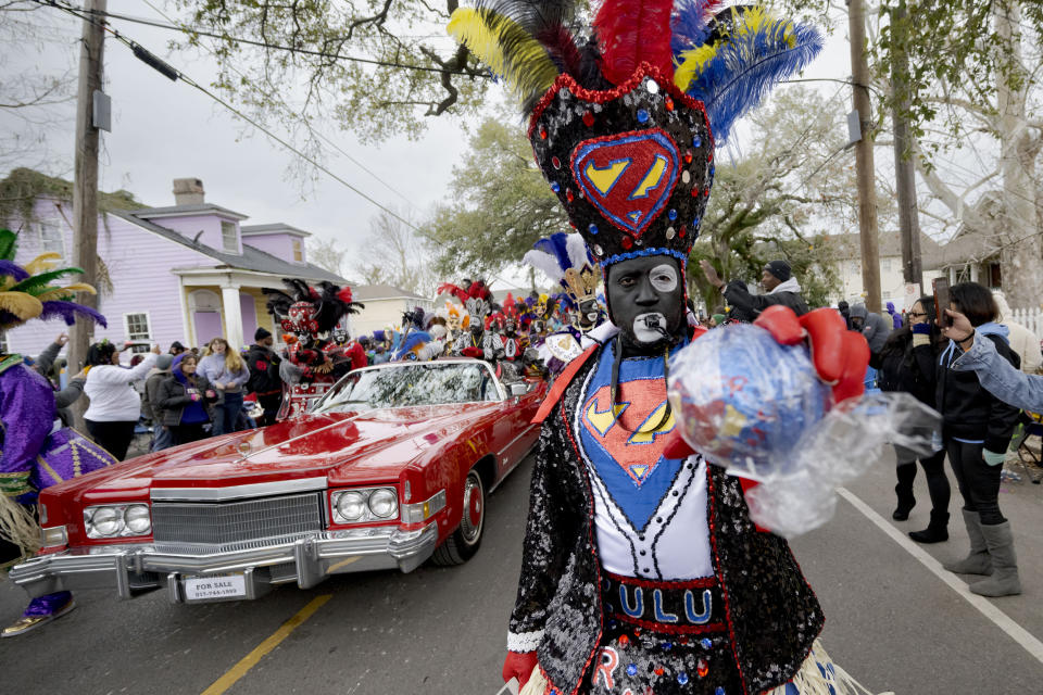 A member of the traditional Mardi Gras group The Tramps holds a traditional coconut throw during the Krewe of Zulu Parade on Mardi Gras Day in New Orleans, Tuesday, Feb. 13, 2024. (AP Photo/Matthew Hinton)