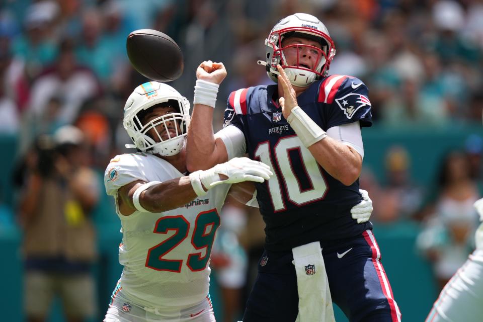 Miami Dolphins safety Brandon Jones (29) knocks the ball away from New England Patriots quarterback Mac Jones (10) in the second quarter of Sunday's game at Hard Rock Stadium in Miami Gardens. The Dolphins recovered the ball and scored a touchdown.