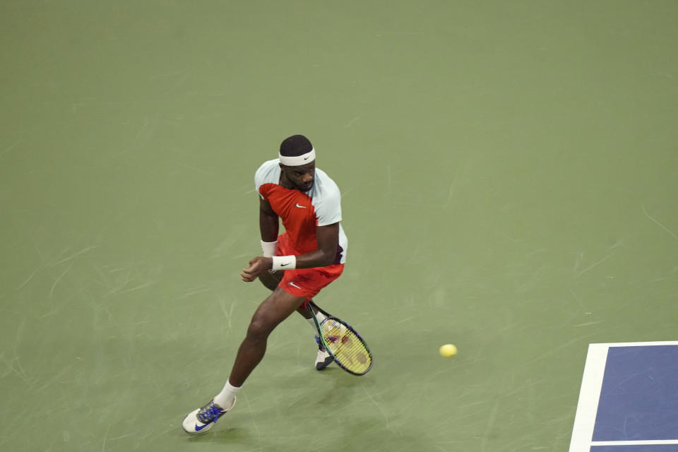 Frances Tiafoe, of the United States, returns a shot between his legs to Carlos Alcaraz, of Spain, during the semifinals of the U.S. Open tennis championships, Friday, Sept. 9, 2022, in New York. (AP Photo/Mary Altaffer)