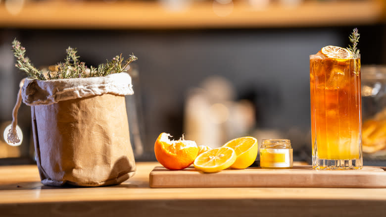 Cocktail with rosemary, orange slices, and honey