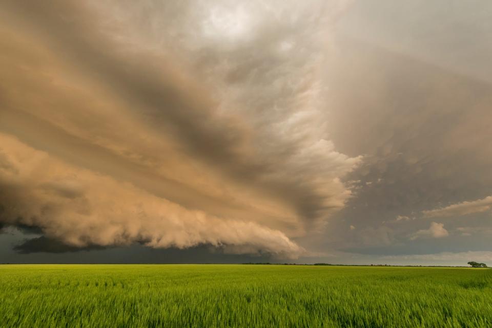 Dark clouds over a green field in Kansas.