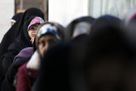 Iranians queue for voting in the parliamentary elections at a polling station in Tehran, Iran, Friday, Feb. 21, 2020. Iranians began voting for a new parliament Friday, with turnout seen as a key measure of support for Iran's leadership as sanctions weigh on the economy and isolate the country diplomatically. (AP Photo/Vahid Salemi)