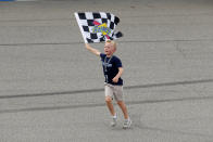 Kevin Harvick's son, Keelan, runs with the winners flag after a NASCAR Cup Series auto race at Michigan International Speedway in Brooklyn, Mich., Sunday, Aug. 11, 2019. (AP Photo/Paul Sancya)