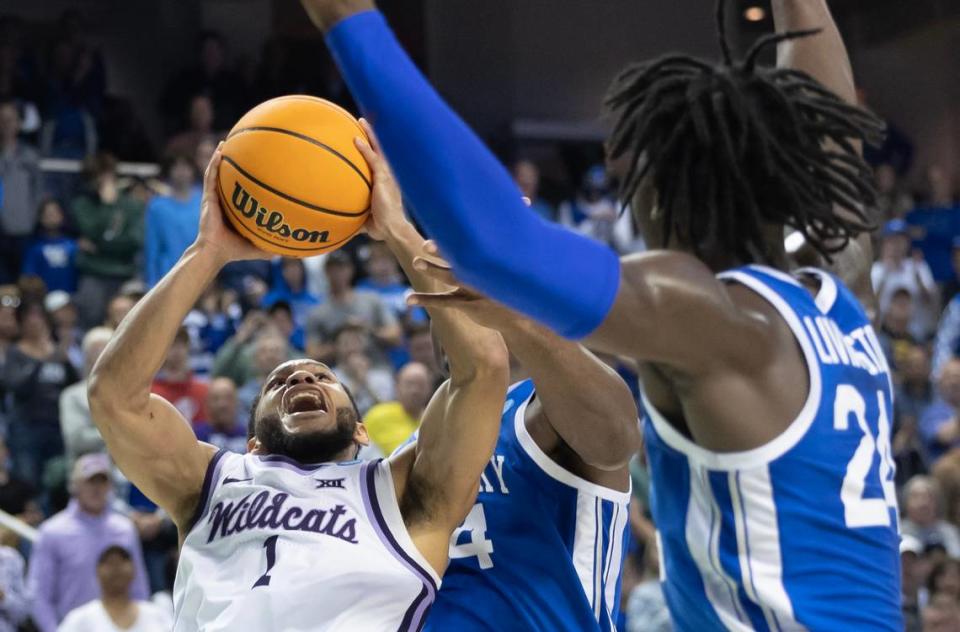 Kansas State’s Markquis Nowell somehow gets a floater to go under heavy defense from Kentucky during the second half of their second round NCAA Tournament game in Greensboro, NC on Sunday.