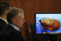 Former New England Patriots tight end Aaron Hernandez (L) and his attorney Charles Rankin sit next to an image of Odin Lloyd from the medical examiner's office during Hernandez' murder trial at Bristol County Superior Court in Fall River, Massachusetts February 4, 2015. Hernandez is accused of the murder of semi-professional football player Lloyd in 2013. REUTERS/Brian Snyder (UNITED STATES - Tags: CRIME LAW SPORT FOOTBALL)