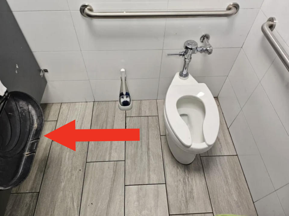 Aerial view of the distance between the toilet bowl and the dispenser.