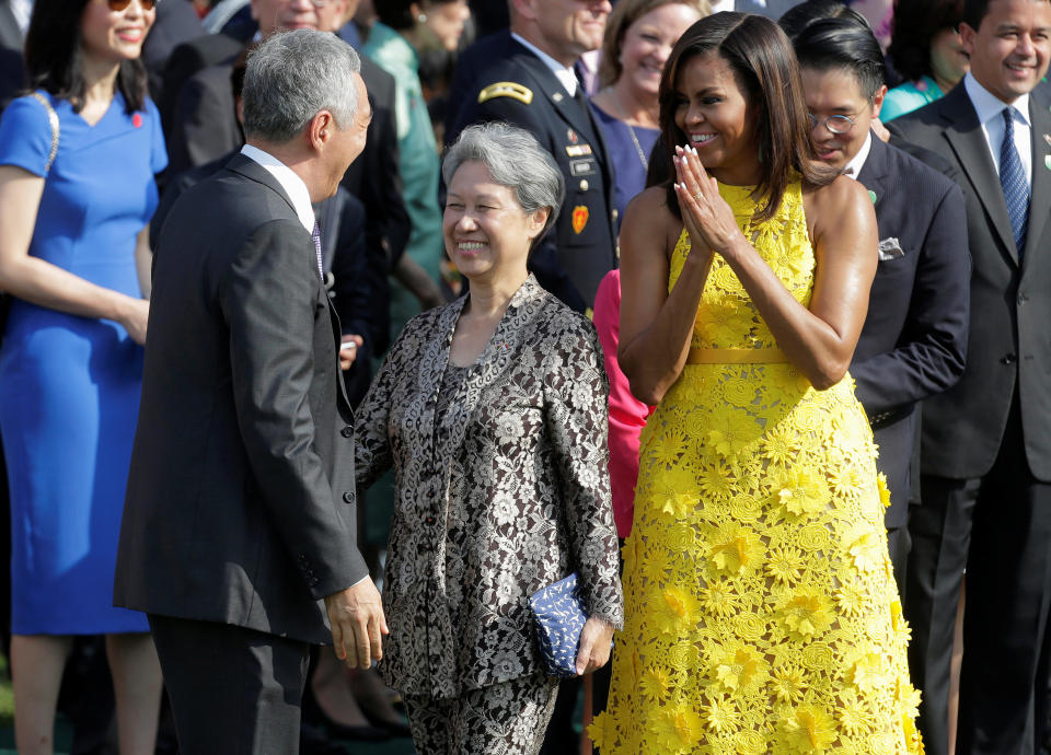 U.S. First Lady Michelle Obama and Mrs. Lee Hsien Loong greet Singapore Prime Minister Lee Hsien Loong during an official arrival ceremony at the White House in Washington.