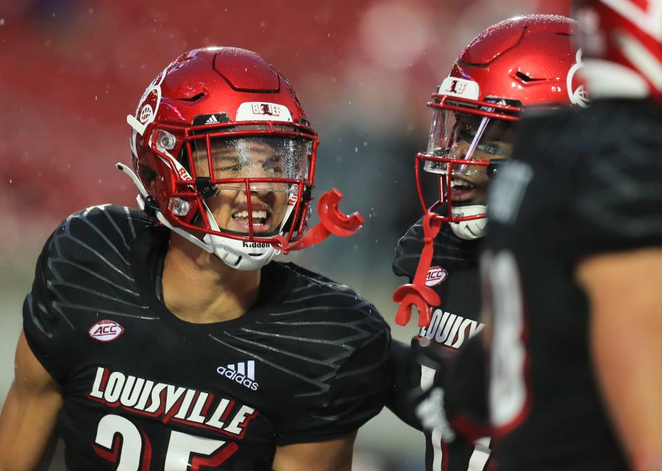 Louisville's Josh Minkins, left, celebrates with teammate Qwynnterrio Cole after Minkins made an interception in the end zone against Boston College. UofL is now 4-3 and breaks a two-game losing streak. Oct. 23, 2021