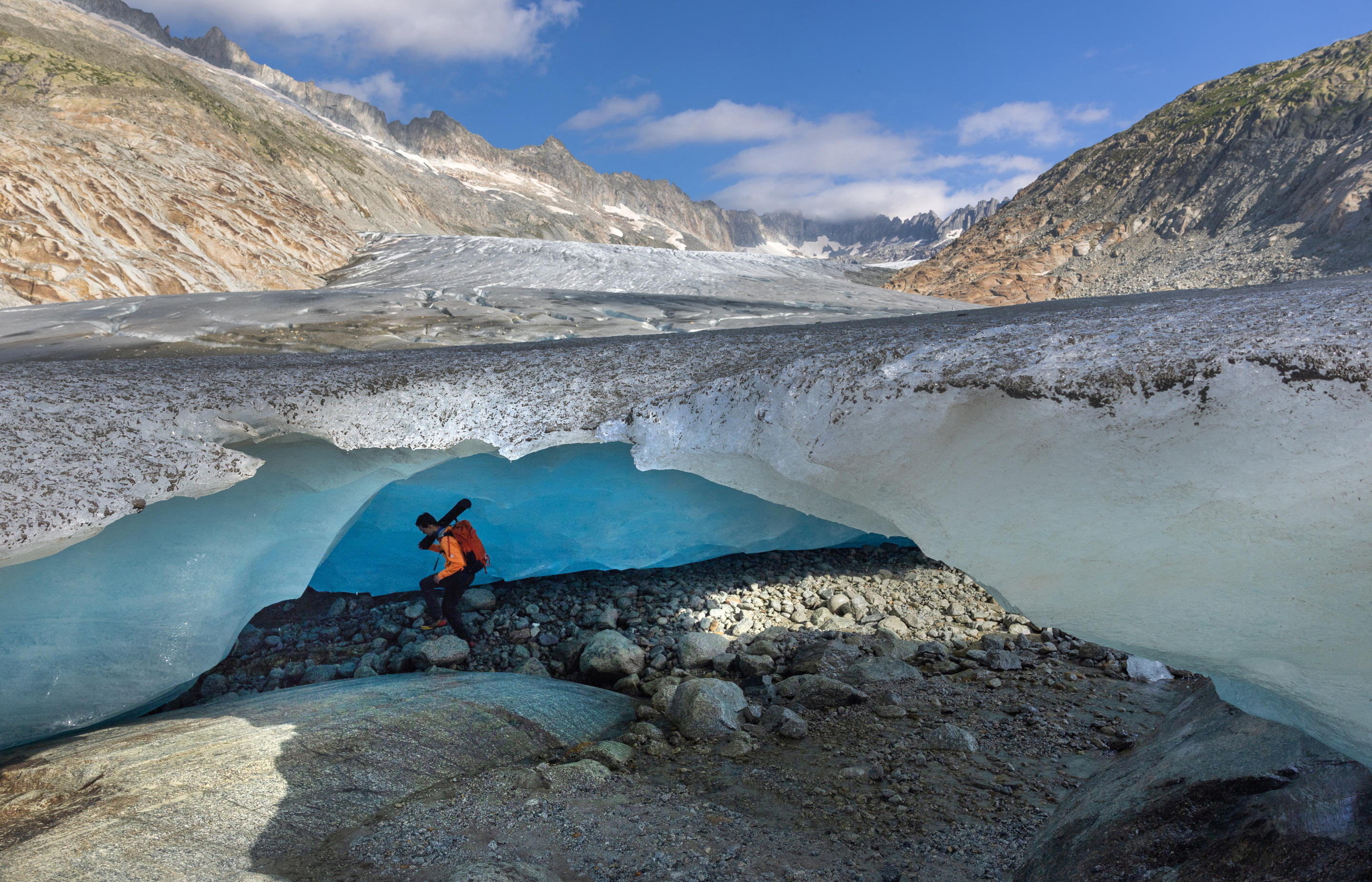 Glaciologist Matthias Huss enters an ice cave at the tongue of the Rhone Glacier in Obergoms, Switzerland, on Aug. 27.