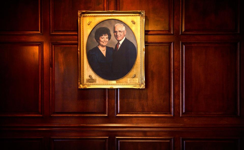 A portrait of the restaurant founders, Chris and Melba Poulos, hangs on the wall at the entrance to Chris's Steakhouse on Raeford Road.